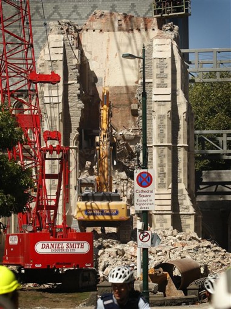 A crane removes one side of the wall of the Christchurch Cathedral on Friday.